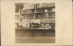 Man Standing Behind Grocer's Counter Postcard