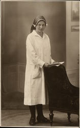 Portrait of Woman Standing at Back of Chair in Uniform Postcard