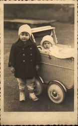 Photograph of Young Children with Wicker Stroller Postcard