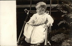 Baby wearing White Gown sitting in Pram Postcard