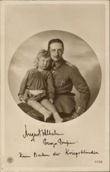 Photograph of Man in German Uniform holding Child on his Lap Postcard