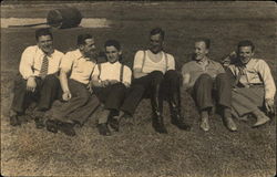 Group of Men Sitting on Grass Postcard Postcard