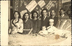 A Family Standing by a Bed Postcard