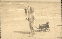 Two Children in the Ocean & One on the Beach with her Toys Postcard Postcard