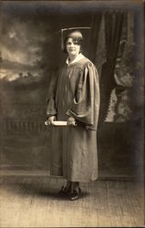 Brunette Woman in Graduation Cap & Gown holding Diploma Postcard