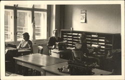 Man and Two Women using Typewriters in an Office Setting Postcard