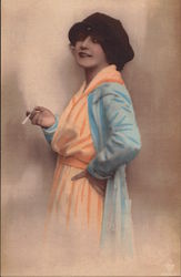 Woman In Orange Dress and Blue Coat Holds a Cigarette Postcard