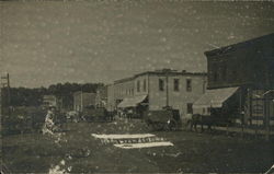 Street Scene Showing Carts and Buildings Rembrandt, IA Postcard Postcard