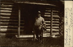 Hunter Outside Log Cabin Postcard