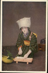 Geisha cutting food Postcard