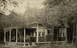 House with porch, surrounded by trees Postcard