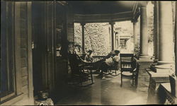 Relaxing on Porch of 132 Main Street Postcard