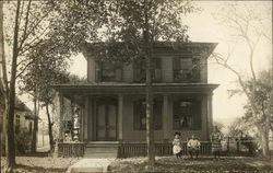 Family In Front of Residence Postcard