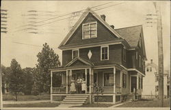 Family on Porch of Home Postcard