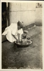 Woman Bathing a Child in the Street - Panama Postcard Postcard