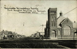 Seventh St. Looking North, First Baptist Church on Corner Postcard