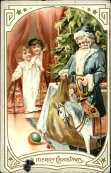 A Merry Christmas - With Santa Unloading Toys in front of Tree and Children Peaking from Curtain Santa Claus Postcard Postcard