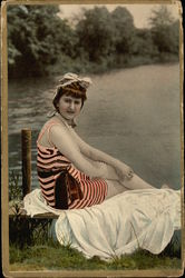 Woman in Pink and Black Striped Bathing Suit on Bench by the Water Postcard