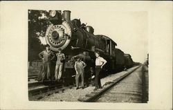 Four Men on Railroad Tracks Next to Locomotive 8570 Postcard