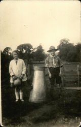 A boy scout and a girl stand outdoors Postcard