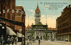 Welcome Arch and Union Depot in the background, showing lower Seventeenth Street Denver, CO Postcard Postcard