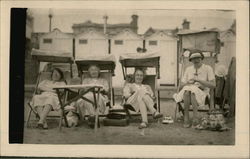 Older women relaxing at the beach in the early 20th century Postcard