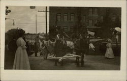 A horse-drawn carriage in a early 20th century parade. Postcard