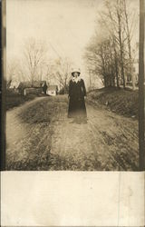 Outdoor photograph of a woman in the early 20th century Postcard