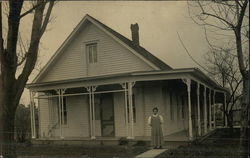 Photograph of a woman in front of a residence in the early 20th century Willshire, OH Postcard Postcard