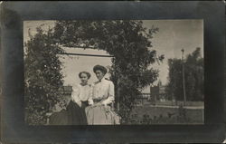 Two Women Sitting Outdoors Postcard