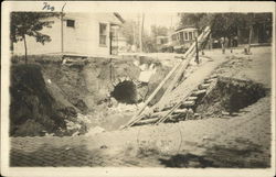 Steetcar tracks leading into a big hole in the street, from the storm of July 1912 Illinois Postcard Postcard