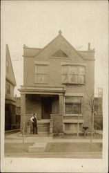 Man Posing In Front of Brick Home Men Postcard Postcard