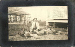 Photograph of a man with chickens in the early 20th century Postcard