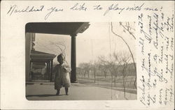 Photograph of a baby on a porch in the early 20th century Postcard