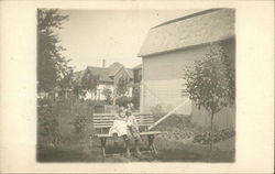 Two Children Hugging on a Bench Jackson, MI Postcard Postcard