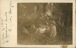 Woman sitting by Campfire in Woods Postcard