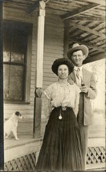 Couple Standing by Home with Dog Postcard