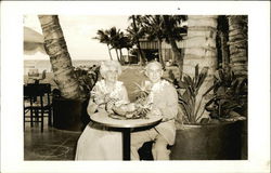 Couple Posing at Table with Fruit and Leis Honolulu, HI Postcard Postcard Postcard