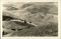 Cars and People Stopped on a Long Curvy Road Postcard