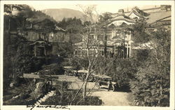 Model Ts outside two asian style mansions Postcard