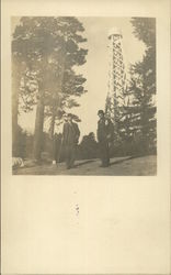 Two Men in Front of a WaterTower Postcard Postcard Postcard