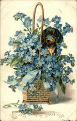 Loving Birthday Greetings - Dog in Large Basket of Blue Flowers Postcard