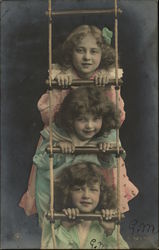 Three Girls Peeking Through a Rope Ladder Postcard