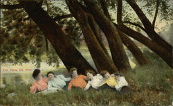 Six ladies lying in the grass beneath some trees Postcard