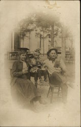 Family Portrait of Woman Graduate, Man Reading, and Child Holding a Drink Postcard