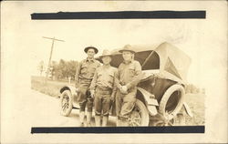 Three Men in Uniform by an Automobile Postcard