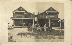 People Sitting on a Large Porch by the Sand Postcard