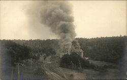 View of Large Building on Fire Near Train Tracks Postcard