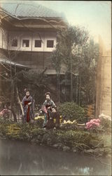 Japanese ladies in kimonos standing in a garden Postcard