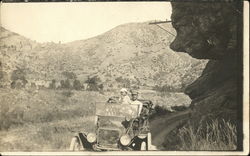 Man and Small Child Riding in Car Postcard